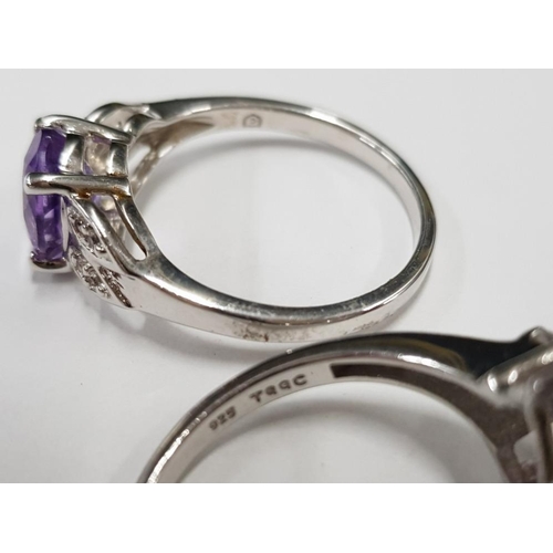 299 - TWO SILVER AND PURPLE STONE RINGS STAMPED SIZE R 1/2 7G GROSS