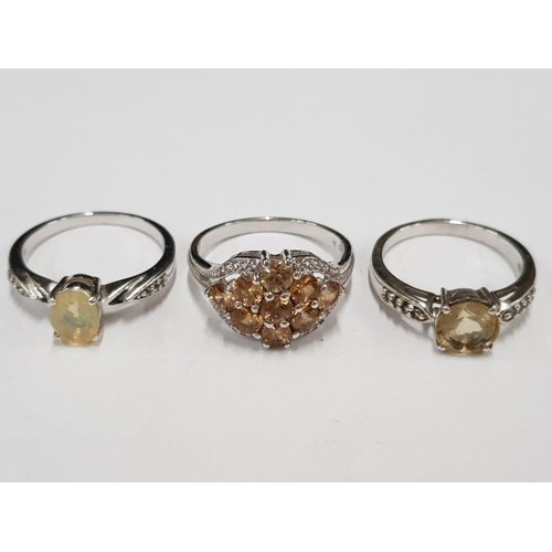 300 - THREE SILVER AND YELLOW STONE RINGS STAMPED SIZES R 1/2 AND T 1/2 11.2G GROSS