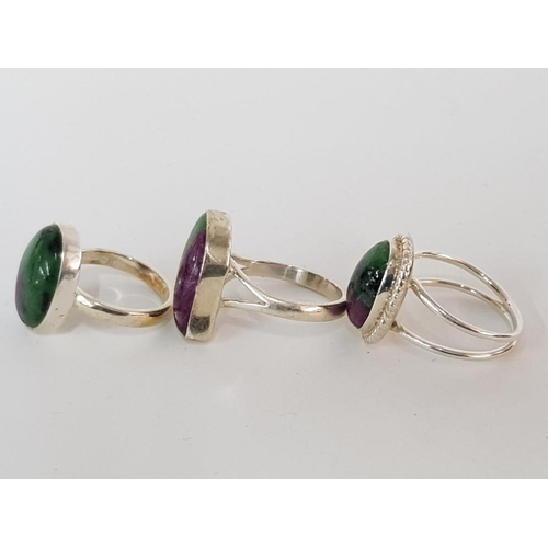 43 - THREE SILVER GREEN AND PURPLE HARDSTONE RINGS STAMPED SIZES P 1/2 AND T 1/2