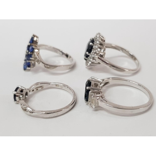 46 - FOUR SILVER AND BLUE STONE RINGS STAMPED SIZES R 1/2 AND S 15.4G GROSS