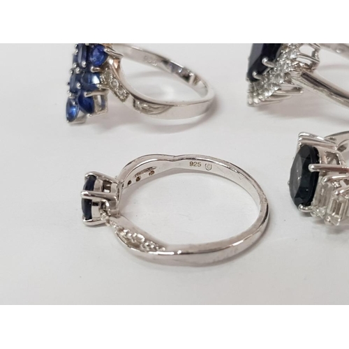 46 - FOUR SILVER AND BLUE STONE RINGS STAMPED SIZES R 1/2 AND S 15.4G GROSS