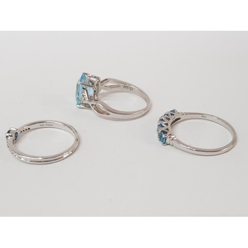 50 - THREE SILVER AND BLUE STONE RINGS STAMPED SIZES P 1/2 AND S 8.5G GROSS