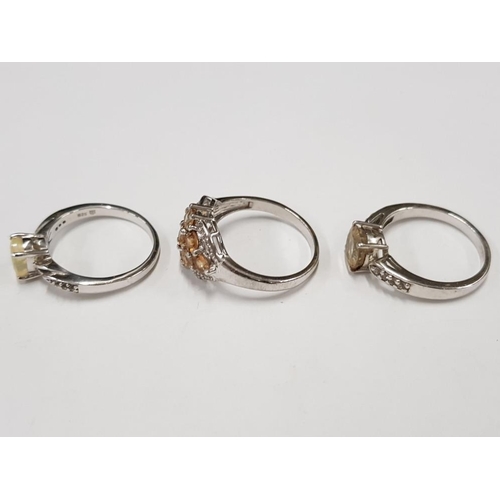 300 - THREE SILVER AND YELLOW STONE RINGS STAMPED SIZES R 1/2 AND T 1/2 11.2G GROSS