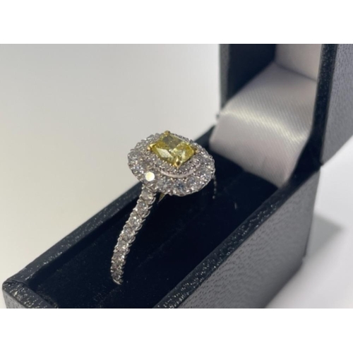 96 - NATURAL FANCY VIVID YELLOW DIAMOND RING 0.50CT CUSHION CUT IN PLATINUM WITH 2 LEVEL DIAMOND HALO IGI... 