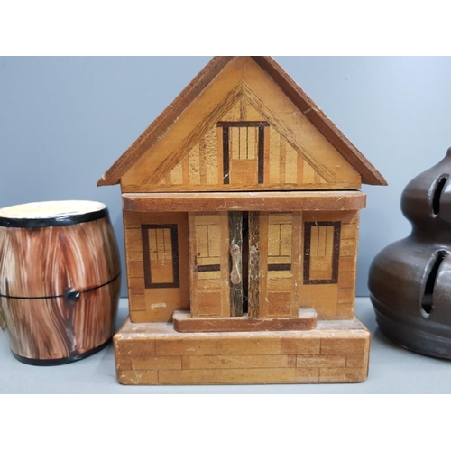 41 - A COLLECTION OF 5 MONEY BOXES TO INCLUDE A BRASS MILK CHURN,  A WOODEN CHALET WITH KEY, A STUDIO POT... 