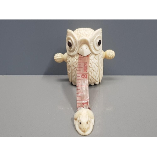 343 - CARVED BONE TAPE MEASURE IN THE FORM OF AN OWL WITH A MOUSE IN ITS MOUTH