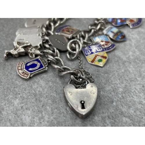 393 - SILVER CHARM BRACELET WITH ASSORTED ENAMELLED TOWN AND COUNTY SHIELDS 58.7G