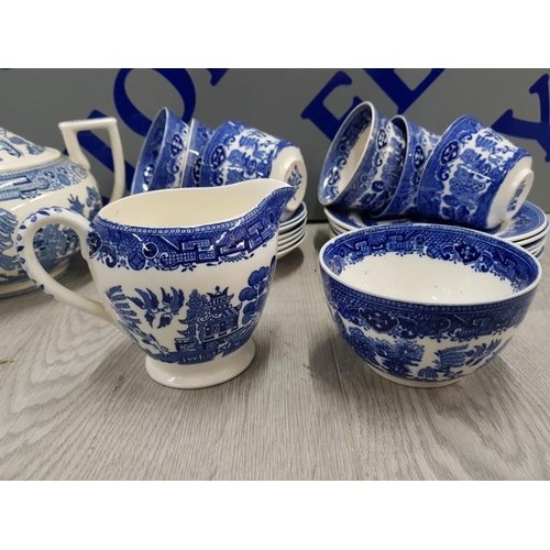 48 - 21 PIECES OF BLUE AND WHITE WILLOW PATTERN INCLUDES TEA POT, MILK JUG, CUPS, SUGAR BOWL AND PLATES