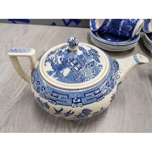 48 - 21 PIECES OF BLUE AND WHITE WILLOW PATTERN INCLUDES TEA POT, MILK JUG, CUPS, SUGAR BOWL AND PLATES