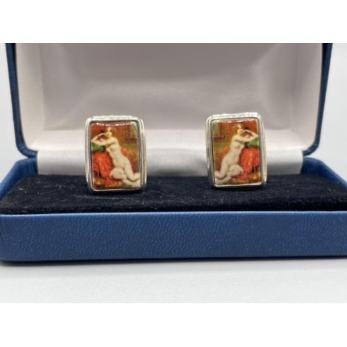 22 - Pair of silver and enamel cuff links depicting nude woman