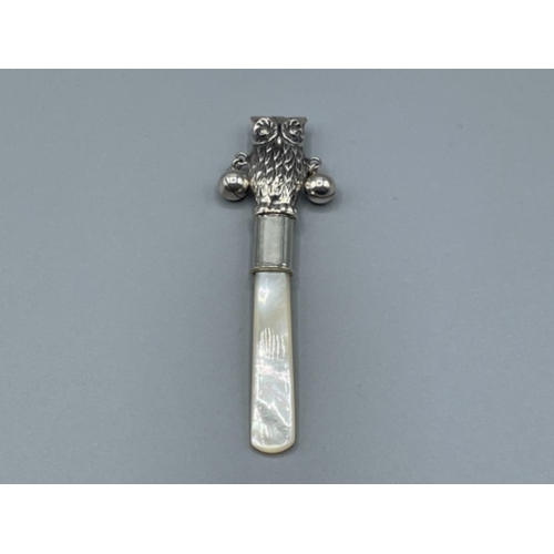 36 - Silver babies rattle in the form of an owl with mother of pearl handle