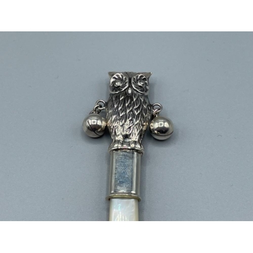 36 - Silver babies rattle in the form of an owl with mother of pearl handle