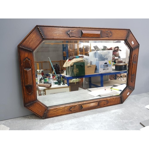 102 - Octagonal arts and crafts oak bevelled mirror, 30x20inch