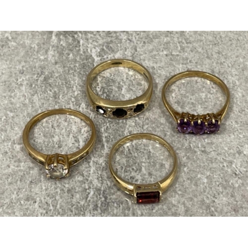 196 - 4 x ladies 9ct gold rings including amethyst, garnet and CZs 9.5G