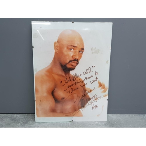 254 - Unframed Marvelous Marvin Hagler picture, signed by the boxing legend along side 