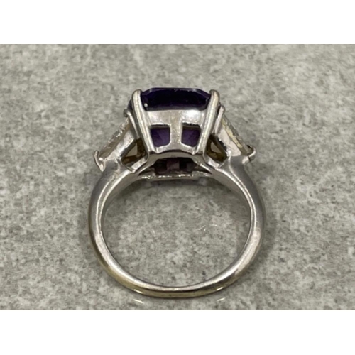 67 - Ladies 9ct white gold purple and white stone ring. Large centre stone and CZ on the shoulders 7.2g s... 
