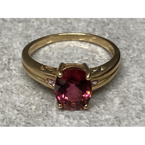 121 - A 9ct yellow gold and purple three stone ring size M 1/2 2.5g gross