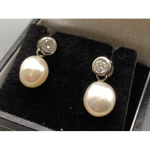 127 - A pair of silver CZ and freshwater Pearl drop earrings