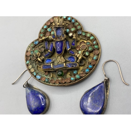 128 - A pair of white metal And blue stone drop earrings together with a multi-stone brooch depicting an A... 