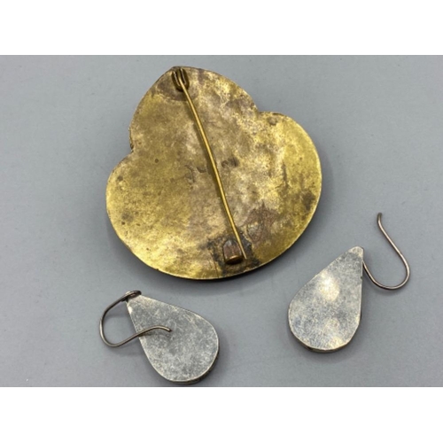 128 - A pair of white metal And blue stone drop earrings together with a multi-stone brooch depicting an A... 