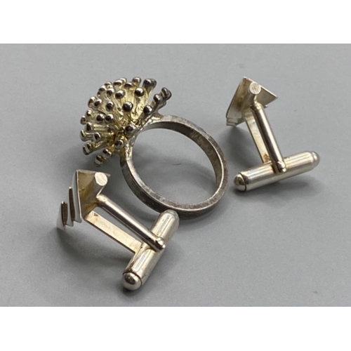 130 - A silver starburst ring, 8.6g - size P, and a pair of white metal cufflinks 6.2g