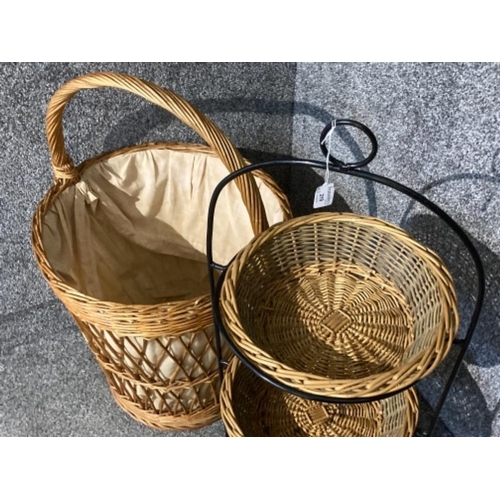 219 - A large wicker laundry basket and a metal and wicker three tier fruit/veg stand