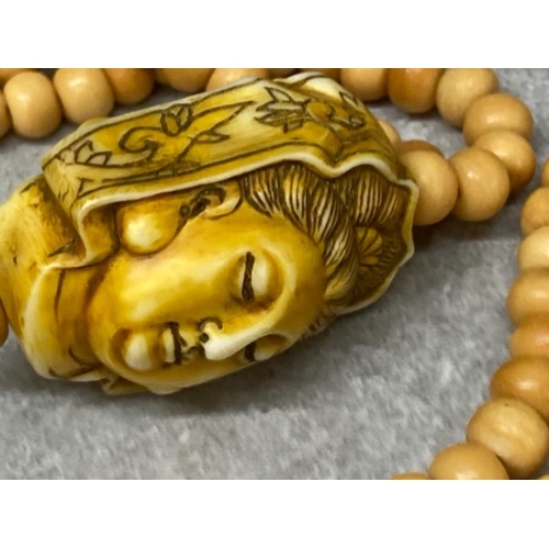 81 - Prayer bead necklace depicting Kuan Yin made of yak bone