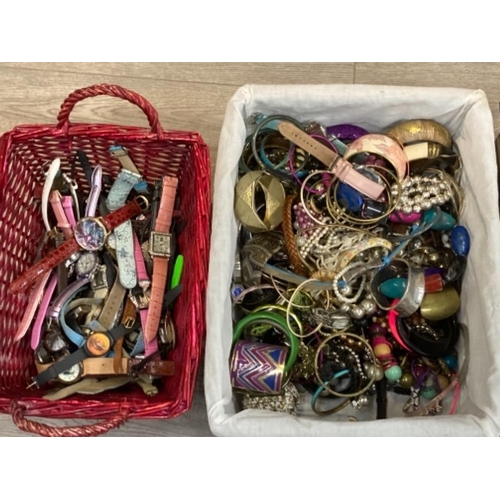 125 - A large quantity of costume jewellery and wristwatches in four boxes