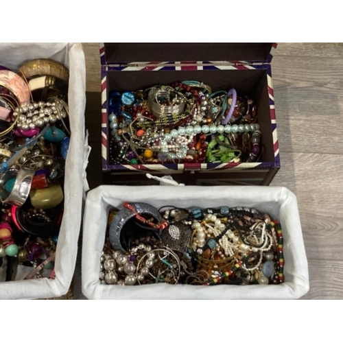 125 - A large quantity of costume jewellery and wristwatches in four boxes