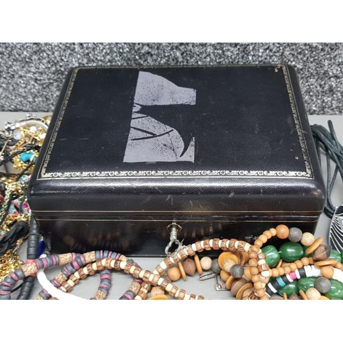 126 - Costume jewellery in a black leather jewellery box with key