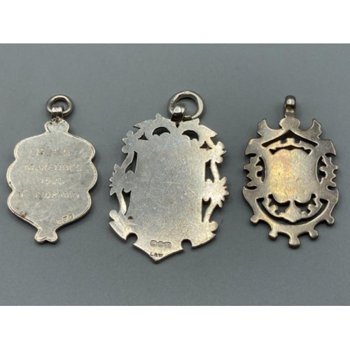 163 - Three ornate silver shields 39.1g