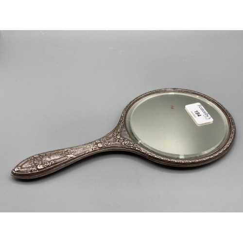 184 - Round shaped white metal hand mirror with ornate back