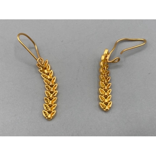 191 - A pair of soft yellow metal earrings of leaf design