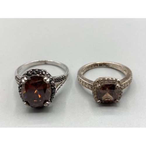 193 - Two silver and CZ rings with brown stones sizes U and P 9.8g gross