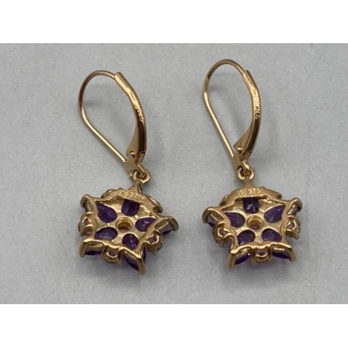 80 - A pair of 9ct yellow gold pink and purple stone earrings of floral design 2.1g gross