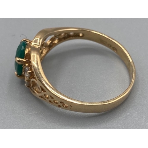 129 - Ladies 18ct yellow gold green and white stone ring size Q 3.3g gross