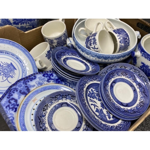 427 - Box containing a quantity of blue & white pottery including willow pattern tea set & vase plus 2 han... 