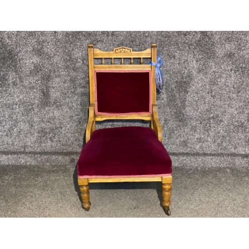 636 - Oak framed nursing chair with red velvet back & seat (back right castor needs reattached)