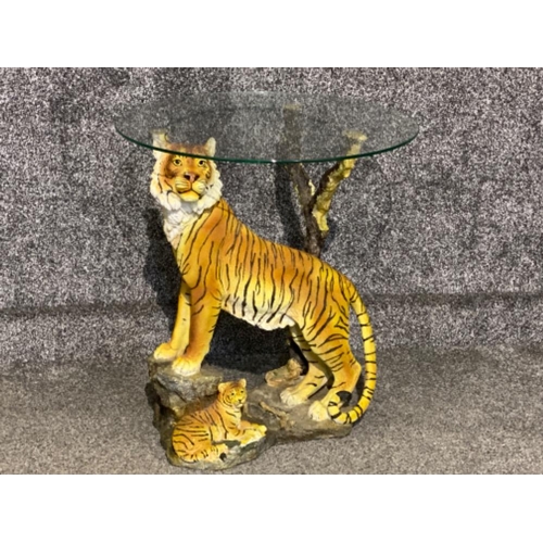 641 - Circular glass topped & resin based occasional table in the form of a mother Sumatran tiger and her ... 