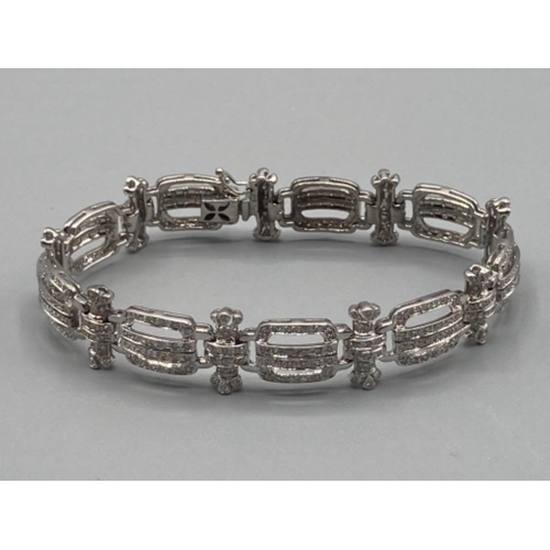 122 - Ladies 14ct white gold and diamond set ornate bracelet with safety catch 20g