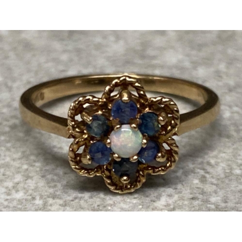 162 - 9ct yellow gold Opal & blue stone ring, ring comprises of central Opal surrounded by 6 blue stones, ... 