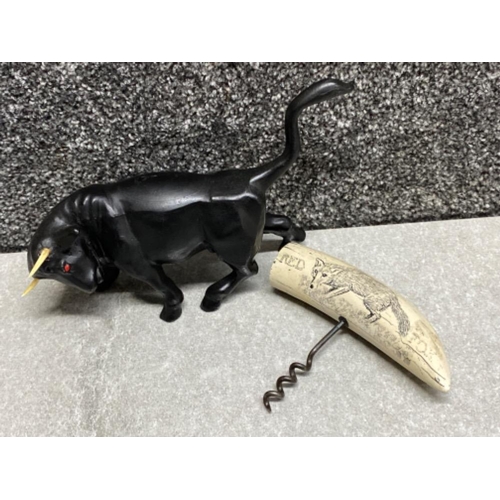 180 - Heavy metal fighting bull ornament together with a vintage corkscrew with resin scrimshaw design han... 