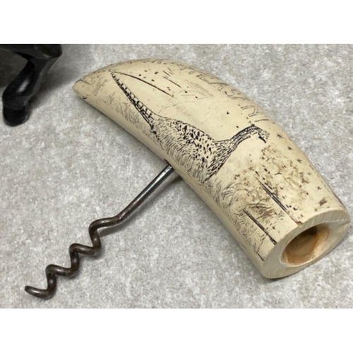 180 - Heavy metal fighting bull ornament together with a vintage corkscrew with resin scrimshaw design han... 