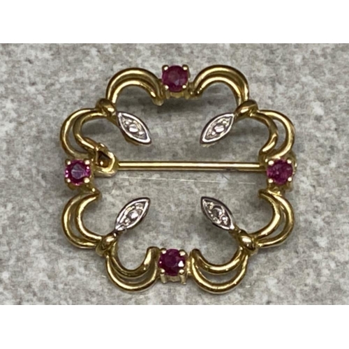 267 - 9ct yellow & white gold brooch set with four rubies, 2.4g