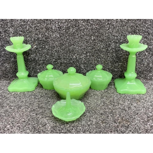 395 - Uranium glass dressing table set of candlesticks, ring holder, 2 small & 1 large lidded pots