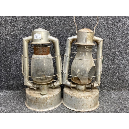 398 - A large pair of hurricane oil lamps