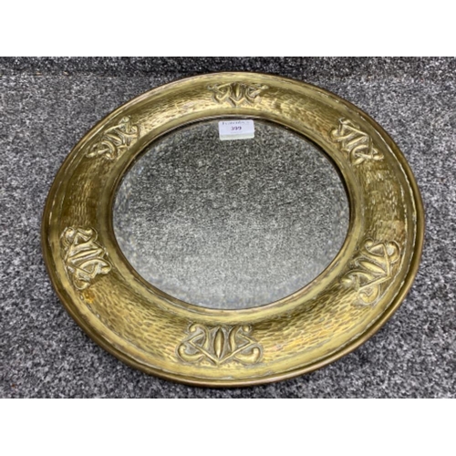 399 - An arts & crafts circular bevelled glass mirror, brass framed with bark & Celtic knot design