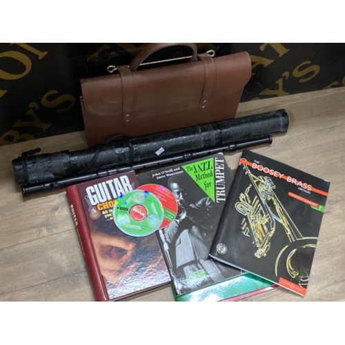 420 - Ebony Irish flute & leather bag of music books & CDs