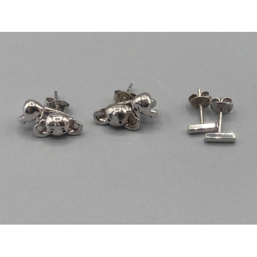 494 - Brand new ex display sterling silver and white stone belly ring and two pairs of silver earrings