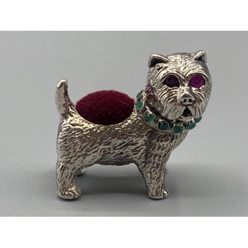 73 - A silver scotty dog pincushion with ruby eyes and emerald collar, 17.4g